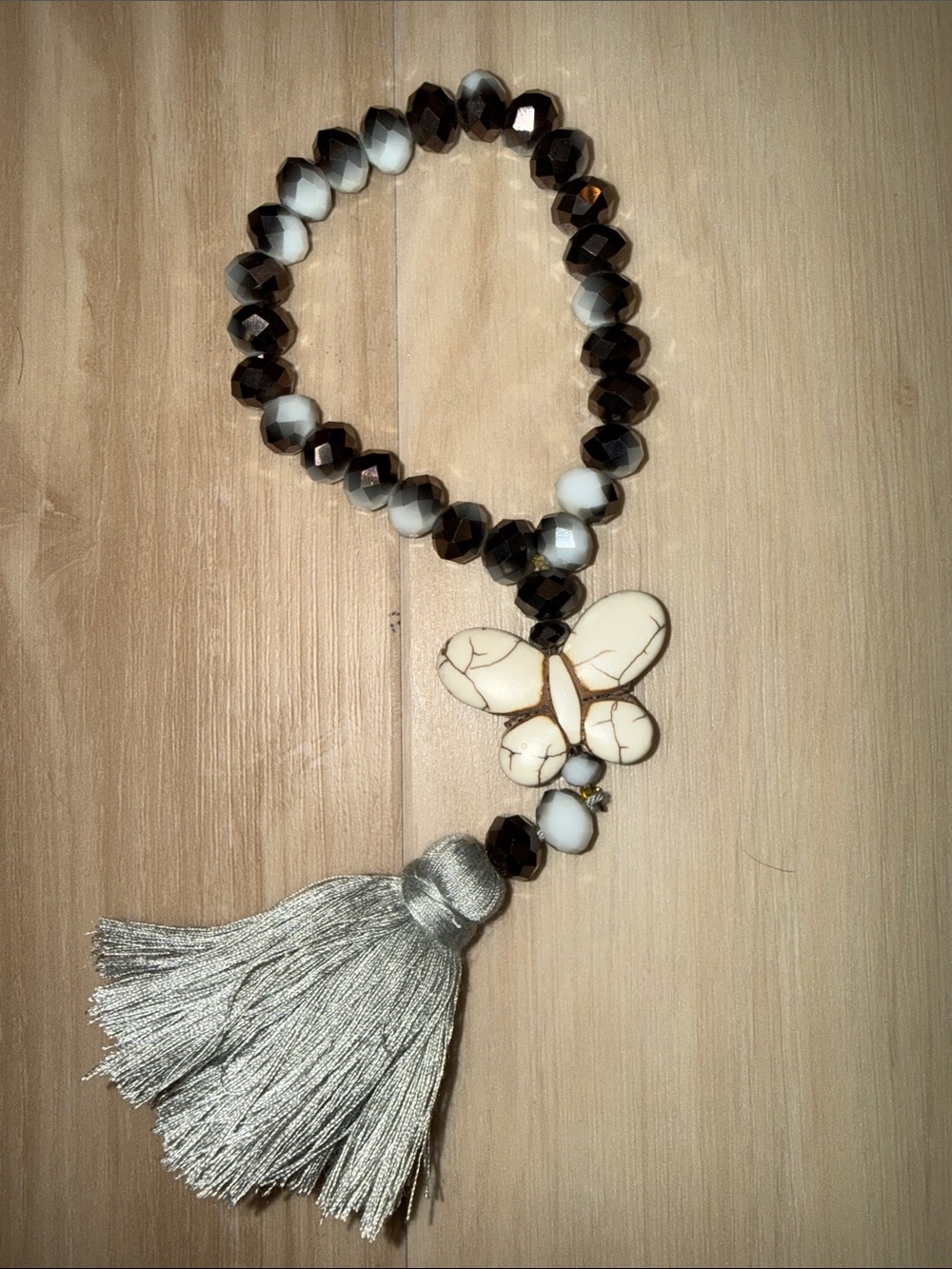 White & Brown Beaded Bracelet with Butterfly Charm and Silver Tassel